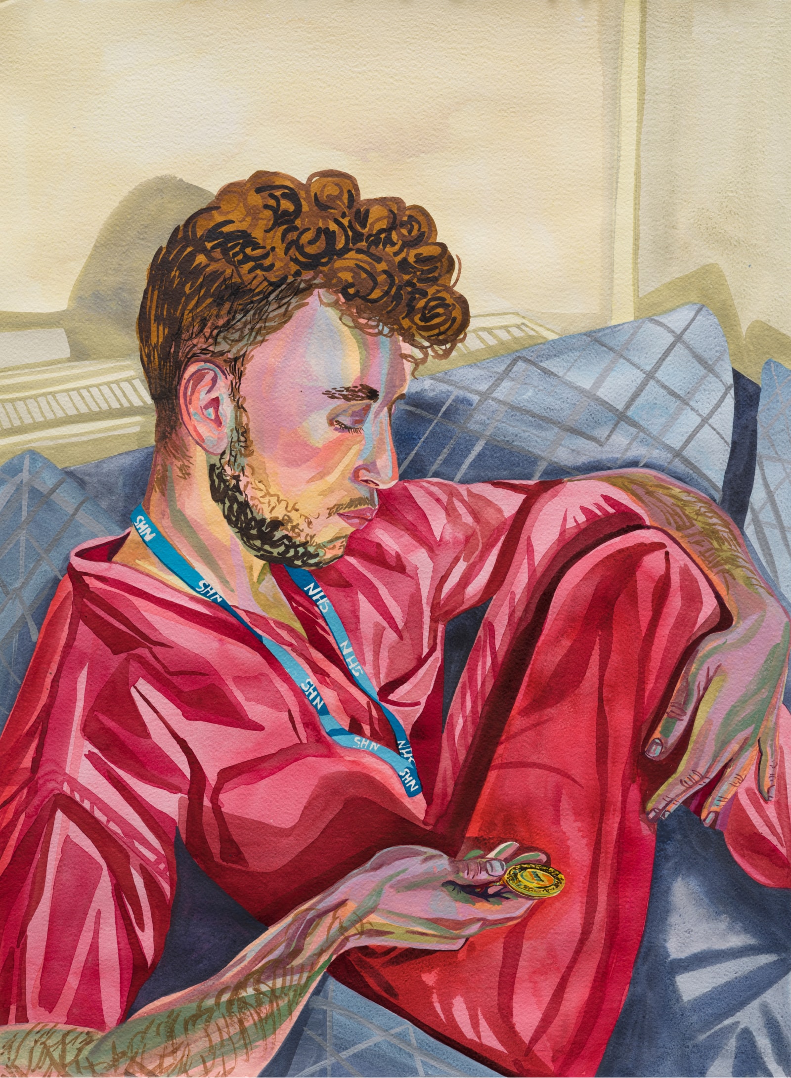 Artwork featuring a young man in red scrubs seated on a blue couch, looking at a gold metal