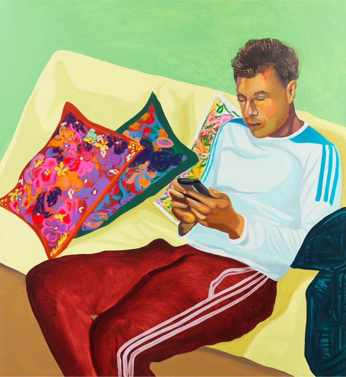 Artwork featuring a man seated on a yellow couch with colorfully printed pillows looking at his smartphone